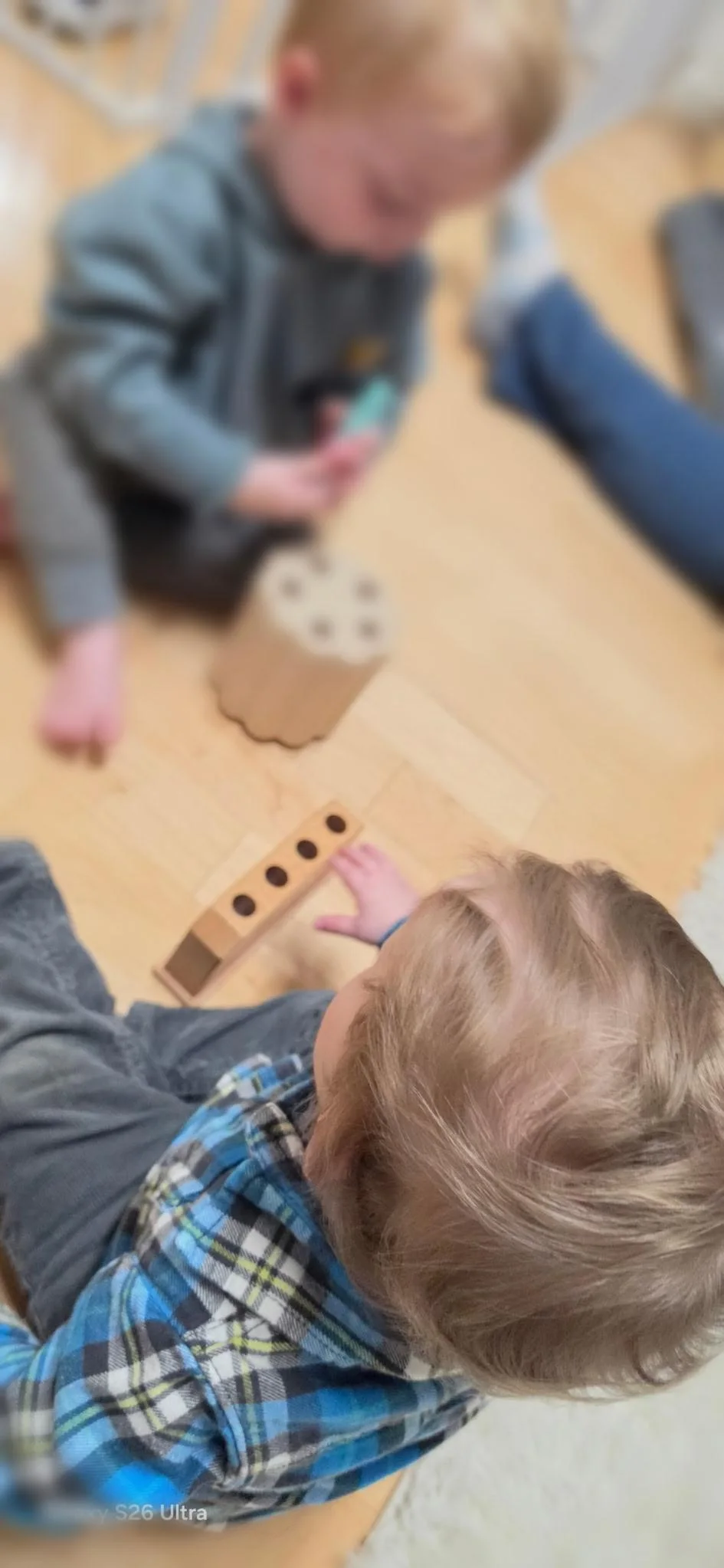 Toddlers playing with wooden toys in the CVA Nursery